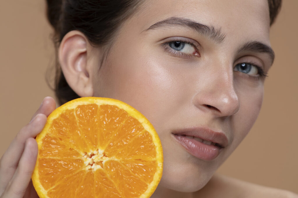 side view woman posing with orange slice